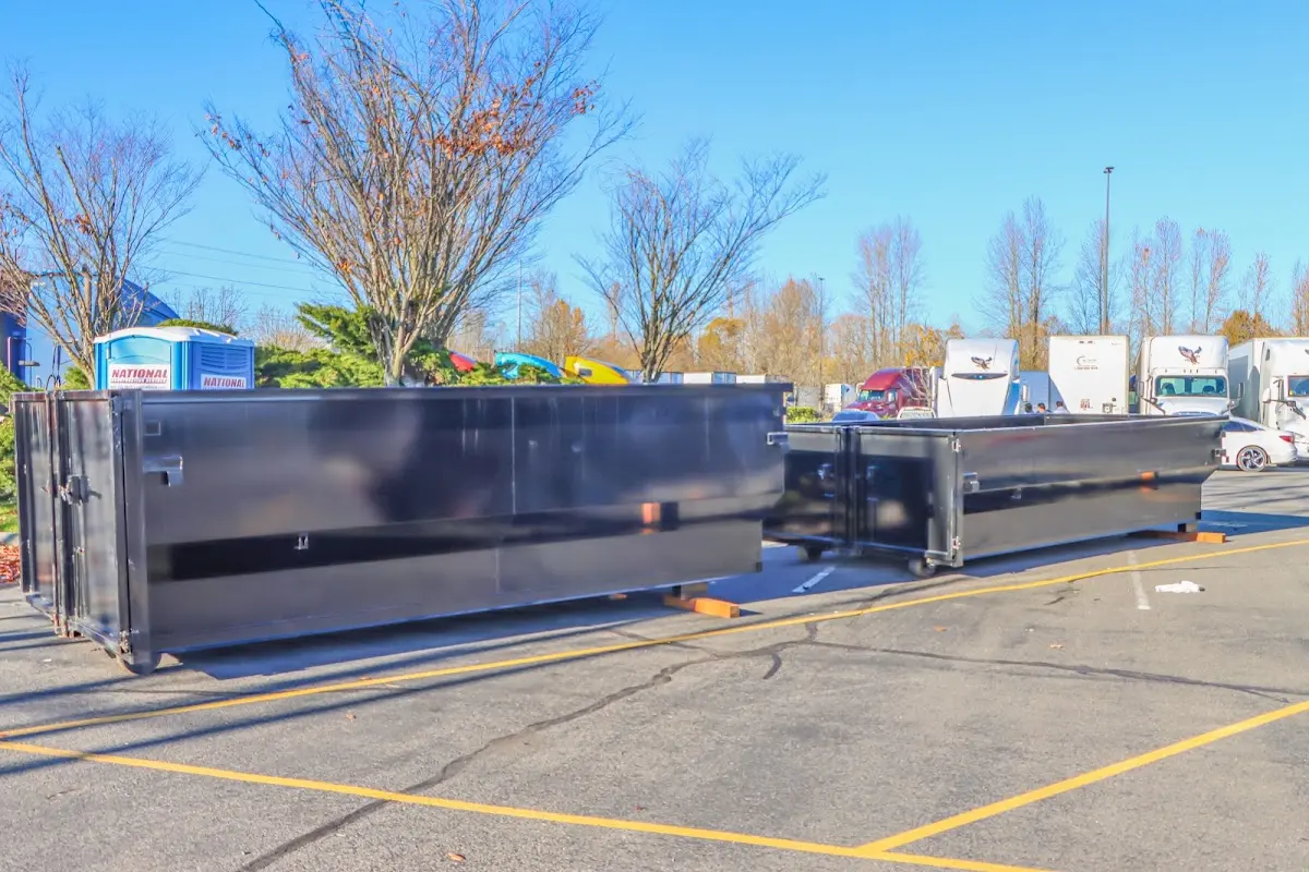 Professional dumpster rental service with roll-off container on residential driveway in East Coventry